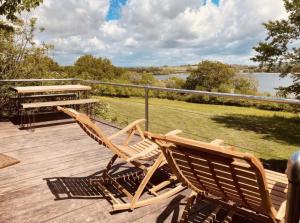 2 sillas de madera sentadas en una terraza con mesa de picnic en Nature's Spectacular en Chew Stoke
