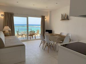 a kitchen and dining room with a view of the ocean at Espardell Beachfront Stay - Ocean Breeze & Sunrise in Es Pujols
