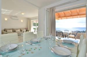 a dining room with a table and a view of the ocean at Villa Silvija in Poljane