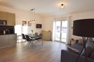 a kitchen and a living room with a table and chairs at Apartment Dora in Primošten