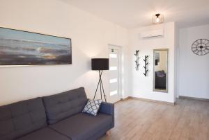 a living room with a couch and a picture on the wall at Apartment Dora in Primošten