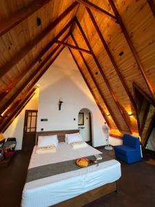 a bedroom with a large bed in an attic at Ella nine arch spice garden in Ella