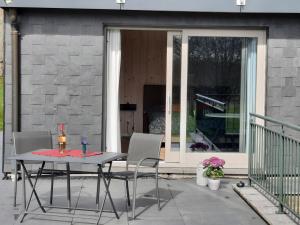 a table and chairs on a patio at Le Grand Ravel in Waimes