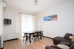 a living room with a table and a couch at Old Riga Julia in Riga