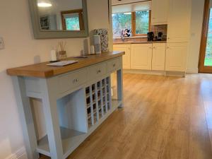 a kitchen with a island with a wooden counter top at Lough Rynn-Lord Leitrim in Rivers Town