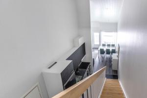 un corridoio con una scala con pareti bianche e pavimenti in legno di StarVillas B305 a Kalajoki