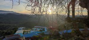 a view of the sun setting over the mountains at Nefzi Guest House in Nefzi