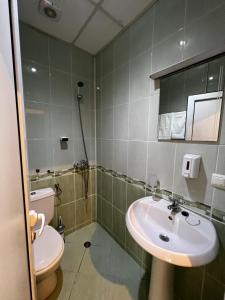 a bathroom with a sink and a toilet at Hotel CENTRAL Balchik in Balchik