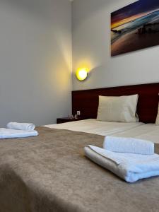 a bedroom with two beds with a headboard at Hotel CENTRAL Balchik in Balchik