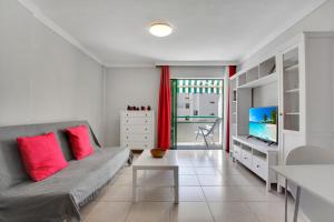 a living room with a couch and a television at Halcon - Costa del Silencio in Costa Del Silencio