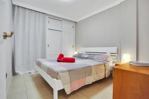 a bedroom with a bed with red pillows on it at Halcon - Costa del Silencio in Costa Del Silencio +28 photos