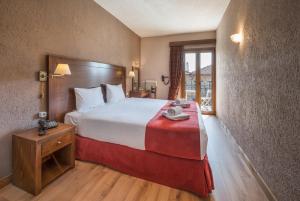 a hotel room with a large bed and a window at Arahova Inn Hotel in Arachova