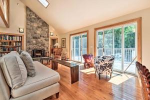 a living room with a couch and a table at Modern Catskills Escape on 25 Acres with Deck! in Mountain Dale