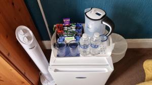 a blender and water bottles on top of a toilet at The Tilstone Guest House in Llandudno