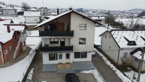 an aerial view of a house in the snow at Prenoćište KRAJINA in Velika Kladuša