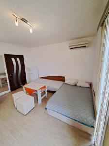a bedroom with two beds and a table in it at spa in Plovdiv