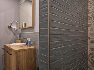 a bathroom with a sink and a brick wall at the breeze in Ahlbeck