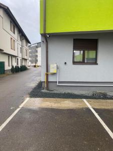 an empty parking lot in front of a building at Nathallie Modern Apartments in Timişoara