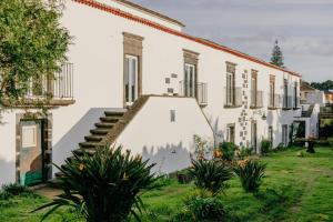 a building with a staircase in front of it at Senhora do Carmo Charm House in Ponta Delgada