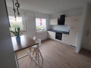 a kitchen with a wooden table and a dining room at Vogelnest - Wohlfühlen im Grünen in Karlsruhe