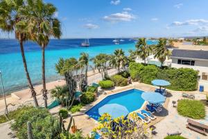 an aerial view of a resort with a swimming pool and the ocean at Bonaire Oceanfront Apartments in Kralendijk