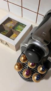 a coffee pot with cupcakes in a holder next to a box at BenedettaMolinaseca VuT in Molinaseca