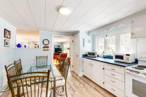 a kitchen with a table and chairs and a counter top at Pineapple Cottage By The Sea in Ogunquit
