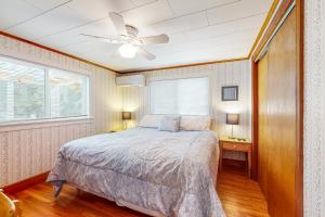 a bedroom with a bed and a ceiling fan at Pineapple Cottage By The Sea in Ogunquit