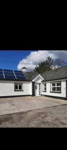 a house with a lot of solar panels on the roof at Holywell cottage 