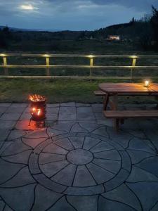 a picnic table with a lit candle next to a fire gmaxwell gmaxwell gmaxwell at Holywell cottage 