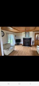 a living room with a couch and a fireplace at Holywell cottage 