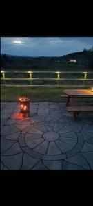 a fire place on a patio with a picnic table at Holywell cottage 