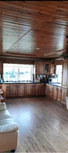 a large kitchen with wooden floors and wooden cabinets at Holywell cottage 