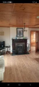 a living room with a fireplace and a tv at Holywell cottage 