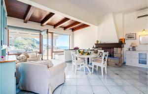 a living room with a white couch and a table at Cozy Home In Forio na With House Sea View in Ischia