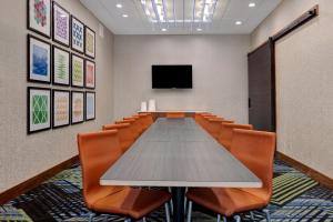 a conference room with a long table and chairs at Holiday Inn Express & Suites - Ann Arbor - University South, an IHG Hotel in Ann Arbor