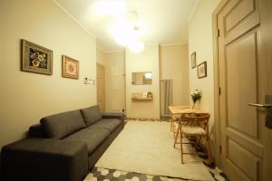 a living room with a couch and a table at Oldtown apartment / New house + elevator in Rīga