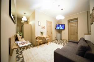 a living room with a couch and a table at Oldtown apartment / New house + elevator in Rīga