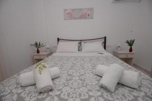 a bedroom with a bed with three pillows on it at Filoxenia Apartments Corfu Rose in Alepou