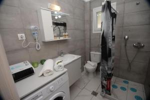 a bathroom with a sink and a toilet and a shower at Filoxenia Apartments Corfu Rose in Alepou
