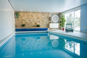 a swimming pool in a house with a pool at Ferienwohnung Wiesenblick mit Terrasse im Landhaus Fischer in Sankt Andreasberg