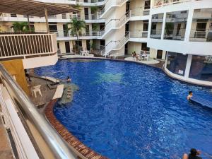 a large swimming pool in the middle of a building at Sheryll Escapes - Kandi big 1 BR, king bed, free housekeeping, fiber fast internet in Angeles