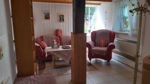 a living room with two chairs and a table at Ferienhof-Jameln-Lueneburger-Heide in Jameln
