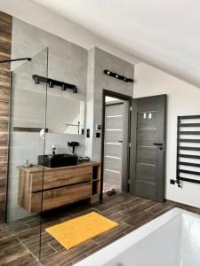 ein Badezimmer mit Waschbecken, Badewanne und Spiegel in der Unterkunft Holiday Resort Šefec in Liptovská Sielnica