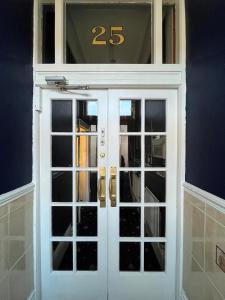 a white door with the number on it at New Derina Hotel in Blackpool