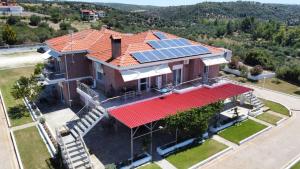 an aerial view of a house with solar panels on the roof at Kiki's Place in Nikiti