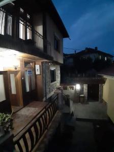 a view of a building with a porch and a fence at **ETNO Vila** - KRUSEVO in Kruševo