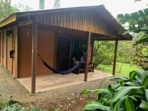 Cataratas Bijagua Lodge, incluye tour autoguiado Bijagua Waterfalls Hike في بيجاغوا: أرجوحة على شرفة منزل