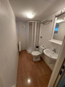 a bathroom with a toilet and a sink at Levidom Residence Rooms in Levice