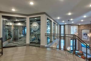 a lobby with a staircase and a gym at Cozy and Bright Apartments at Marble Alley Lofts in Downtown Knoxville in Knoxville